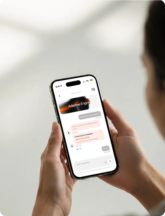 Hands holding a phone showing an Adaptive Engine chat